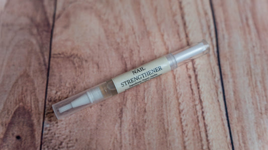 A Wright Creation Nail Strengthener Serum in a clear, eco-friendly applicator pen, infused with natural jojoba oil and plant-based ingredients to nourish and strengthen brittle nails, ideal for sensitive skin and holistic nail care.