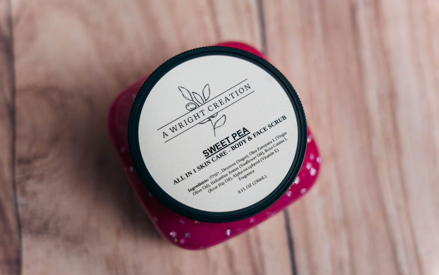 A Wright Creation Sweet Pea all-in-one body and face scrub in eco-friendly packaging, formulated with natural ingredients like olive oil and rosehip oil, ideal for sensitive skin, eczema, psoriasis, and dry skin relief.