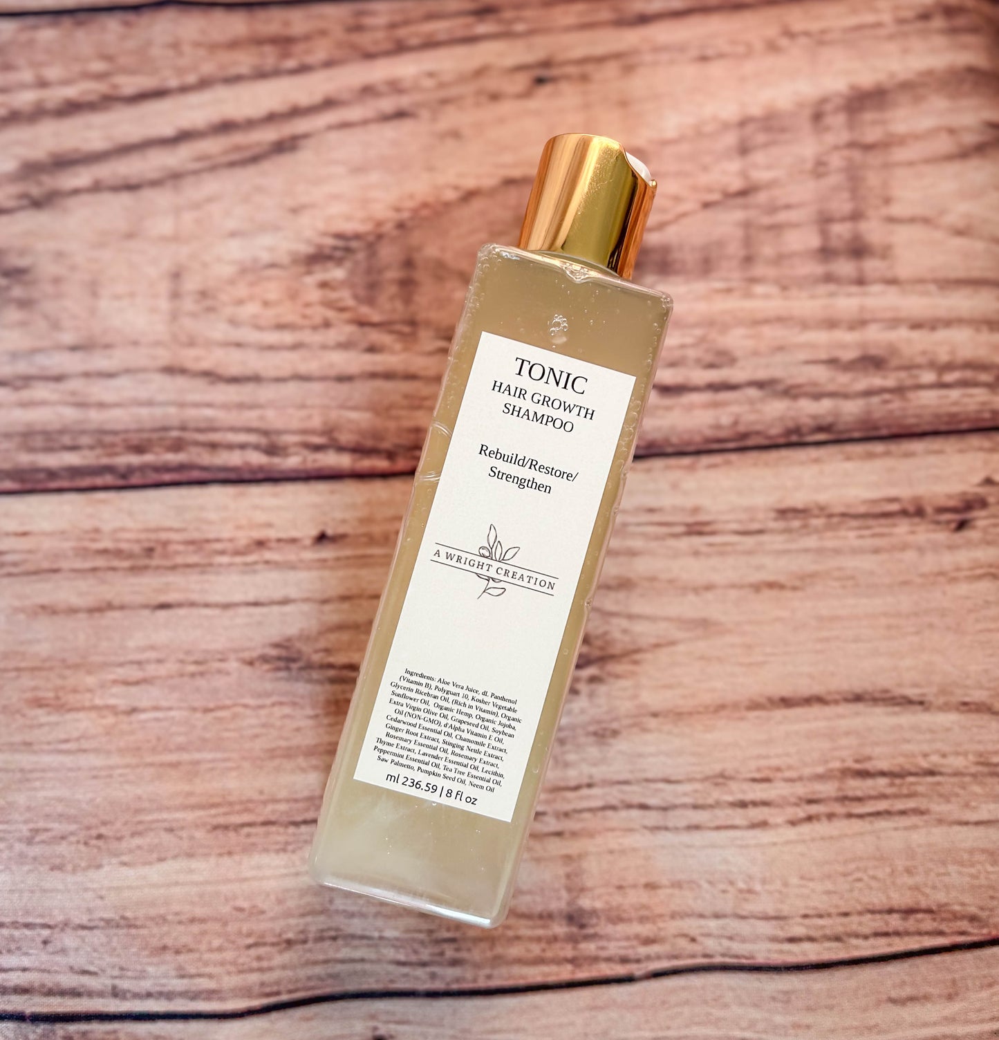 A Wright Creation Tonic Hair Growth Shampoo in eco-friendly packaging with a gold cap, formulated with aloe vera and natural oils to rebuild, restore, and strengthen hair, ideal for sensitive scalps, dry hair, and overall hair health.