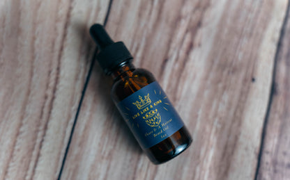 A Wright Creation 'Live Like a King' Beard Oil in an amber glass dropper bottle, featuring natural oils to nourish, condition, and soften facial hair while soothing sensitive skin, ideal for eco-conscious grooming routines.